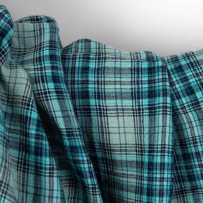 Linstoff med turkise og grå ruter bredt vasket som er mykt, skånsomt