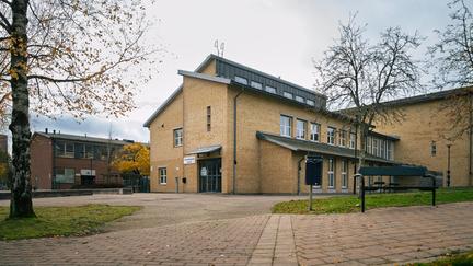 En skolbyggnad i tegel med en entré