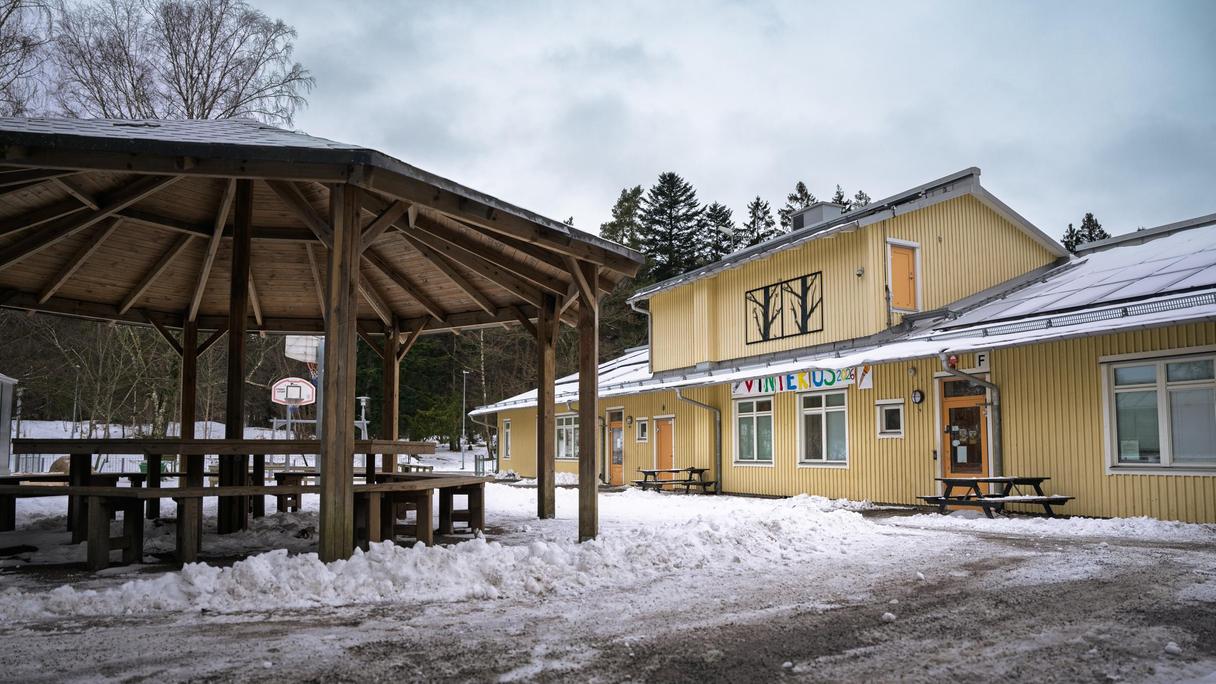Kärrdalsskolans skolgård med några bänkar och bord i fokus.