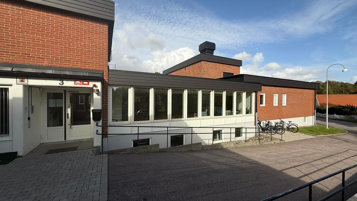 Entrén till Byalagsgatans korttidsboende, röd tegelfasad.