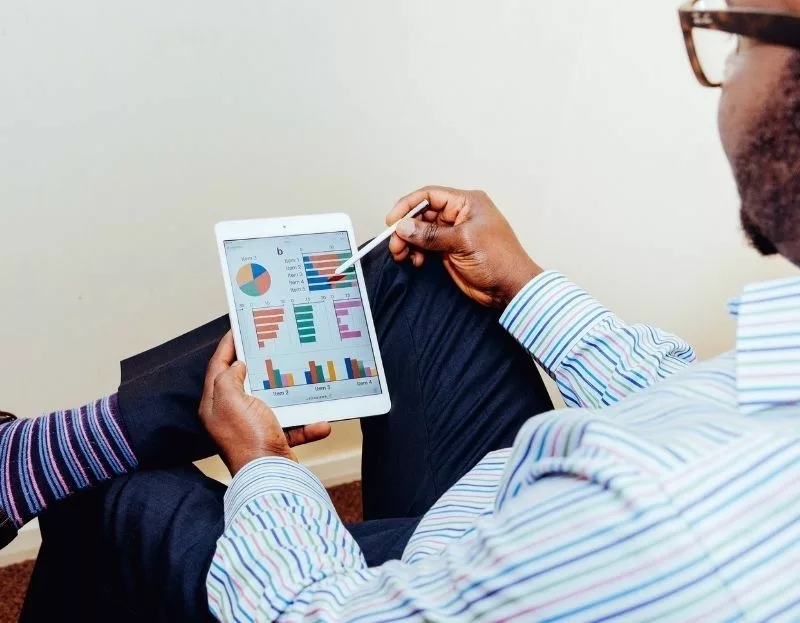 Man looking at graphs on ipad 800x623