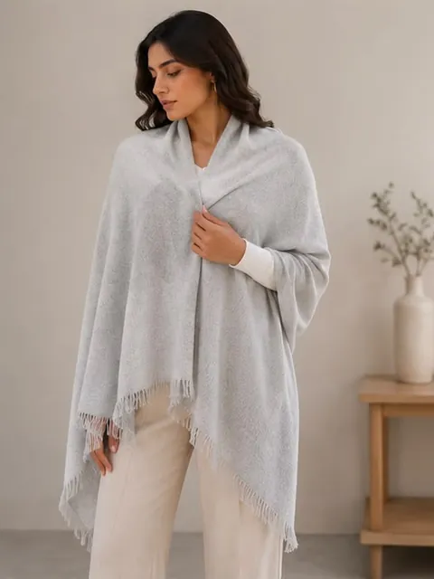 Model wearing the ash pashmina shawl with fringed edges