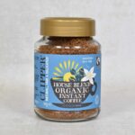 Glass jar of Clipper organic Fairtrade Instant Coffee 100g from front showing label on closed jar.