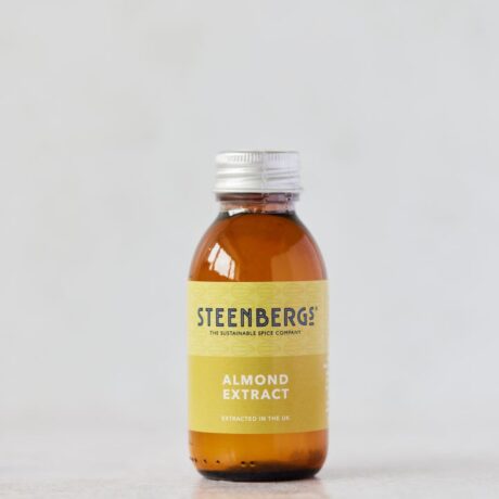 Front of Steenbergs Natural Almond Extract, glass jar, with green label and aluminium cap on.