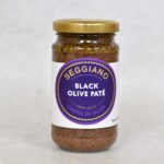 Front view of Seggiano Black Olive Pate, glass jar, with label and gold lid.