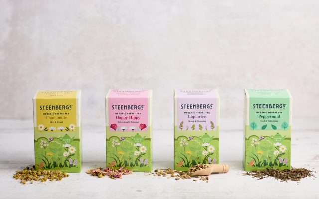 Four boxes of Steenbergs new look herbal teas reflecting the emphasis on nature. with loose leaf tea on spoons in front.