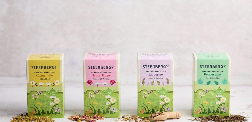 Four boxes of Steenbergs new look herbal teas reflecting the emphasis on nature. with loose leaf tea on spoons in front.