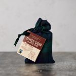 Fairtrade mulled spices in a Black Watch Tartan bag with dark green ribbon tie and tag with instructions and ingredients