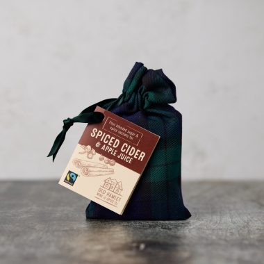 Fairtrade mulled spices in a Black Watch Tartan bag with dark green ribbon tie and tag with instructions and ingredients